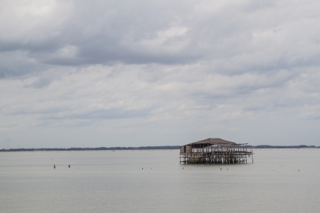 A sea hut used for the owner to stay and guard his cockle farmの写真素材