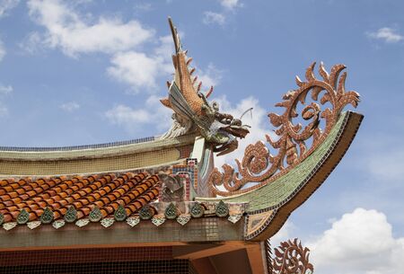 Dragon sculpture made of mosaic on the temple roof の写真素材