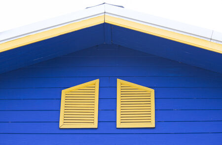 Yellow window of the blue houseの写真素材