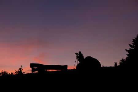 camera man with his camera and tripod, silhouetteの写真素材