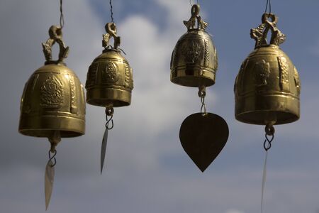 Golden colored brass bells hung in the temple