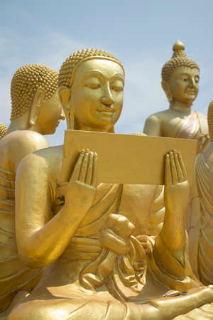 Buddhist's Disciple statue and Big Buddha statueの写真素材