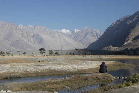 Man looking at the view of Nubra valley, Ladakh, Indiaの写真素材