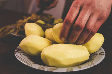 Peeling potatoes with a knife at home