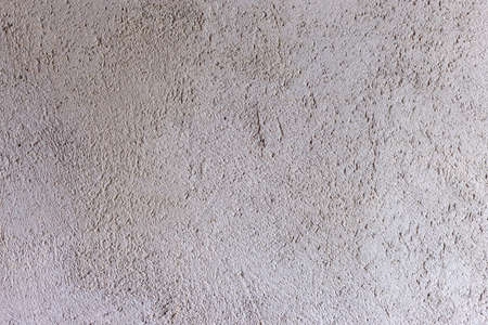Background cement wall. Gray unpainted wall. Rough wall.の写真素材