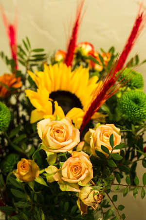 Beautiful bouquets of different colors in a vase on a gray backgroundの写真素材