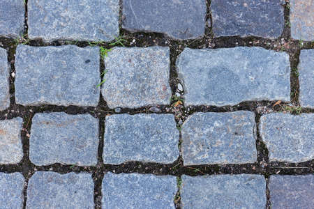 Gray, smooth granite paving stones. Paving stone background.