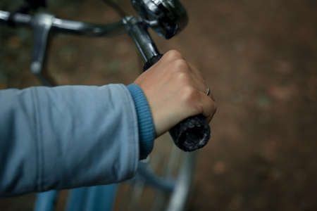 Womans hand on the handlebars of a bicycleの写真素材
