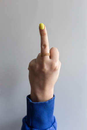 Female hand with extended middle finger