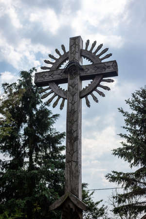 Ancient wooden cross with wood carvings.の写真素材