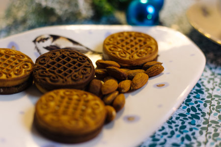 Cookies and almonds on a beautiful plateの写真素材