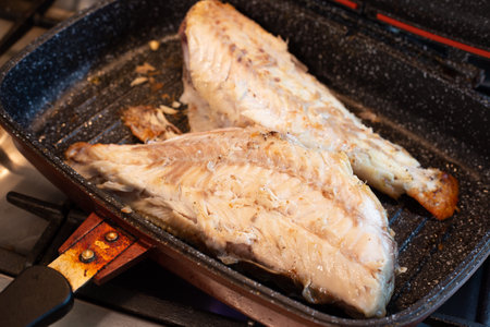 Cooking sea bass in a pan