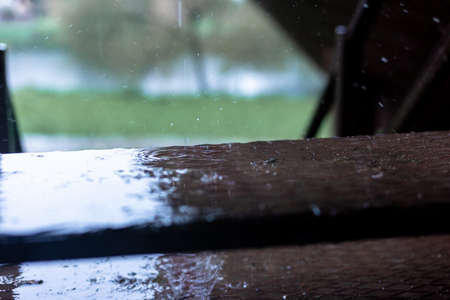 Raindrops dripping on the steps. Brown steps.の写真素材