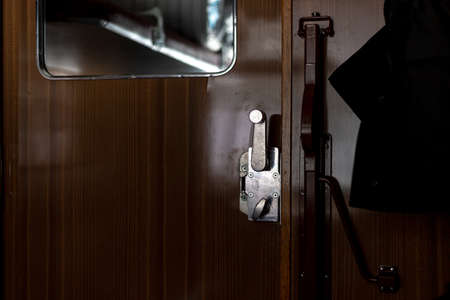 Door and doorknob in a train compartment. Travel by train.