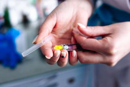 Female hands with a syringe for injection. Vaccination.の写真素材
