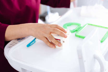 The dentist shows on the model of the jaw how to brush the teeth with a brush