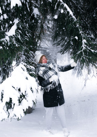 The girl was covered with snow from the tree.の写真素材