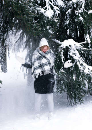 The girl was covered with snow from the tree.の写真素材
