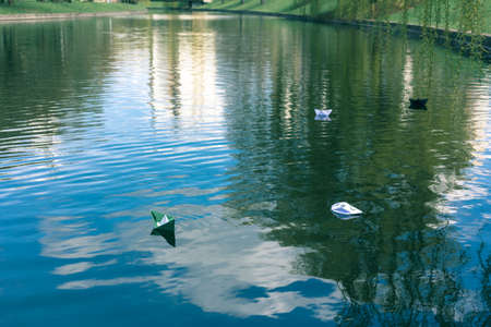 Many paper skiffs float on the waterの写真素材