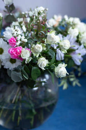 Bouquet of flowers on a blue background. Blooming flowers.の写真素材
