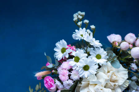 Bouquet of flowers on a blue background. Blooming flowers.の写真素材