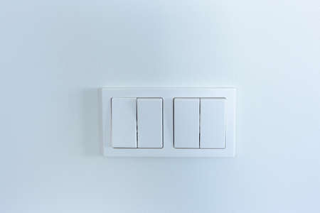 White light switches on a white wall