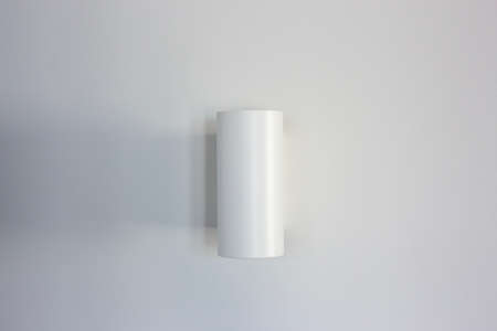 White wall lamp on a white wallの写真素材