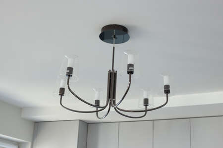 Chandelier with many light bulbs on the ceilingの写真素材