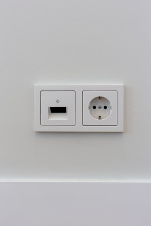 Double electrical socket on a white wall in the roomの写真素材