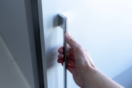 A hand opening a closet door.Wardrobe for things..の写真素材