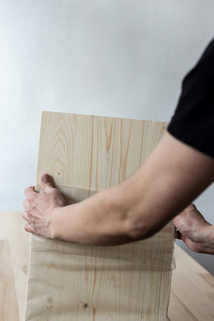 Removing the integral packaging from the furniture board.の写真素材