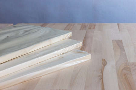 Furniture board in cellophane packaging on a wooden background. Wooden plank.