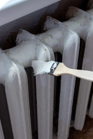 Painting radiators with a special brush. Battery painting.の写真素材