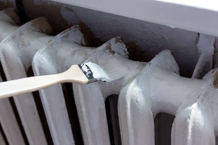 Painting radiators with a special brush. Battery painting.の写真素材