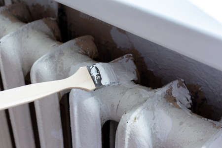 Painting radiators with a special brush. Battery painting.の写真素材
