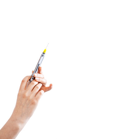 Syringe for injection in female hand on whiteの写真素材