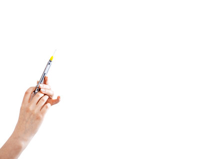 Syringe for injection in female hand on whiteの写真素材