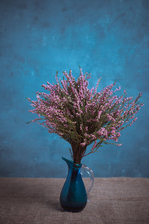Bouquet of heather in a blue vase. Classic still life.の写真素材