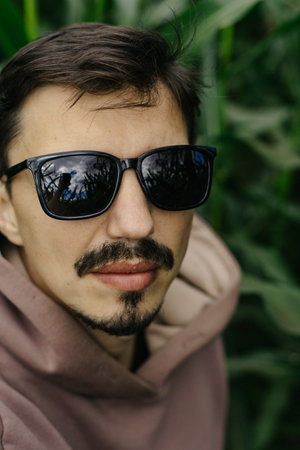 Large male portrait. A man in dark glasses with a mustache and beard.の写真素材