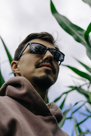 Large male portrait. A man in dark glasses with a mustache and beard.の写真素材