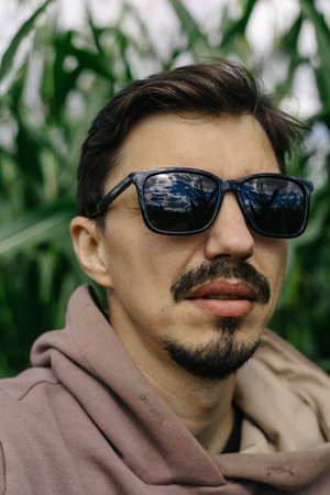 Large male portrait. A man in dark glasses with a mustache and beard.の写真素材