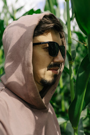Portrait of a hooded man with dark glasses, mustache and beard.の写真素材