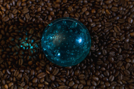 Blue glass bowl on coffee beans. Background from coffee beans.の写真素材