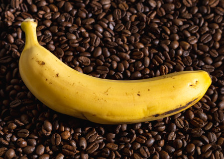 Banana on a background of coffee beansの写真素材
