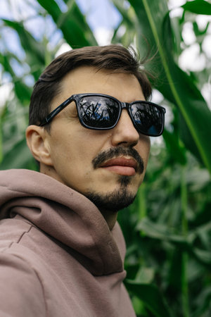 Large male portrait. A man in dark glasses with a mustache and beard.の写真素材