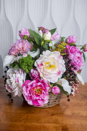 Still life with Bouquet of summer flowers in basketの写真素材