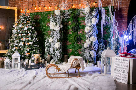 Wonderful Christmas location with imitation of snow, icicles, decorated Christmas tree, children's...