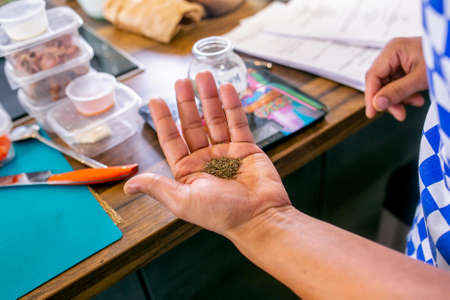Cook holds cumin seeds. Master class in the kitchen. The process of cooking. Step by step. Tutorial....