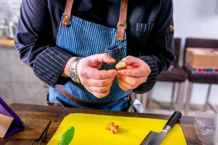 Chef cuts fried fish in batter. Master class in the kitchen. The process of cooking. Step by step....