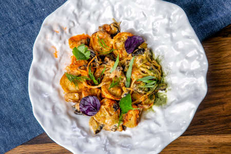 Baked dumplings with mushrooms. Russian cuisine. The work of a professional chef. Dish from a...